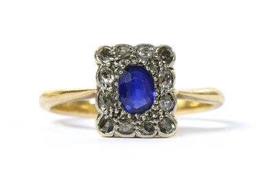 Lot 1034 - A sapphire and diamond cluster ring