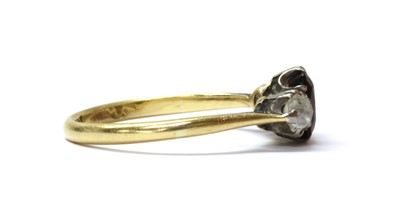 Lot 136 - A gold garnet and diamond three stone ring