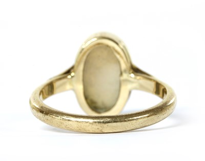 Lot 1058 - A gold single stone opal ring