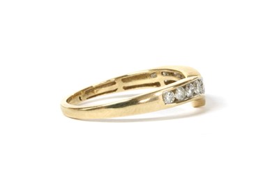 Lot 140 - A gold diamond wishbone-shaped half eternity ring