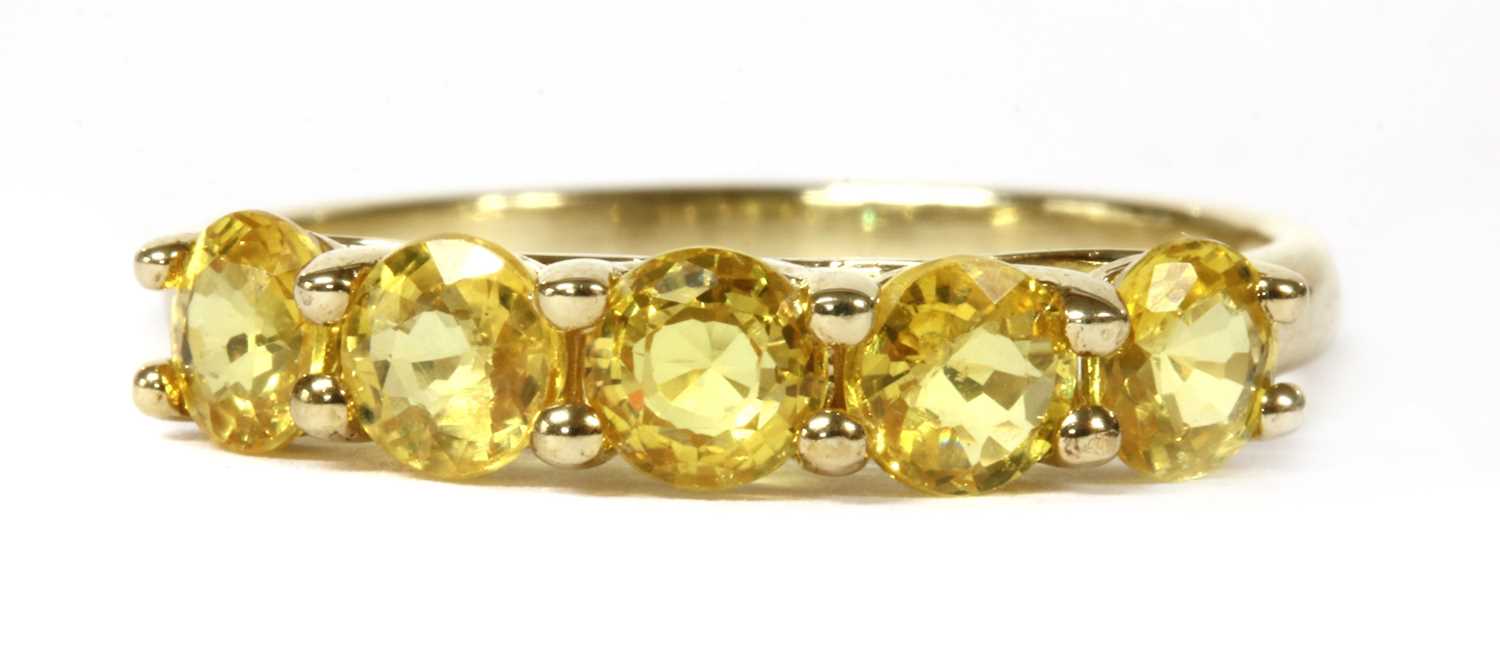 Lot 254 - A gold five stone yellow sapphire ring