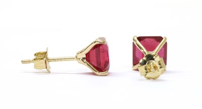 Lot 234 - A pair of gold single stone fracture filled ruby stud earrings
