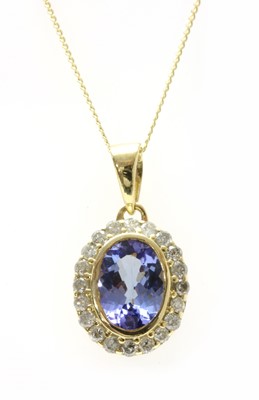 Lot 192 - A gold tanzanite and diamond cluster pendant