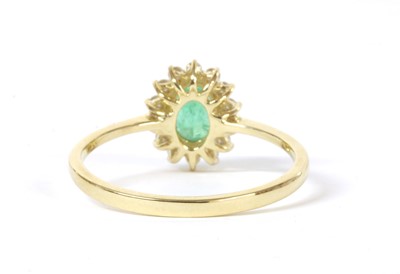 Lot 159 - A gold emerald and diamond cluster ring