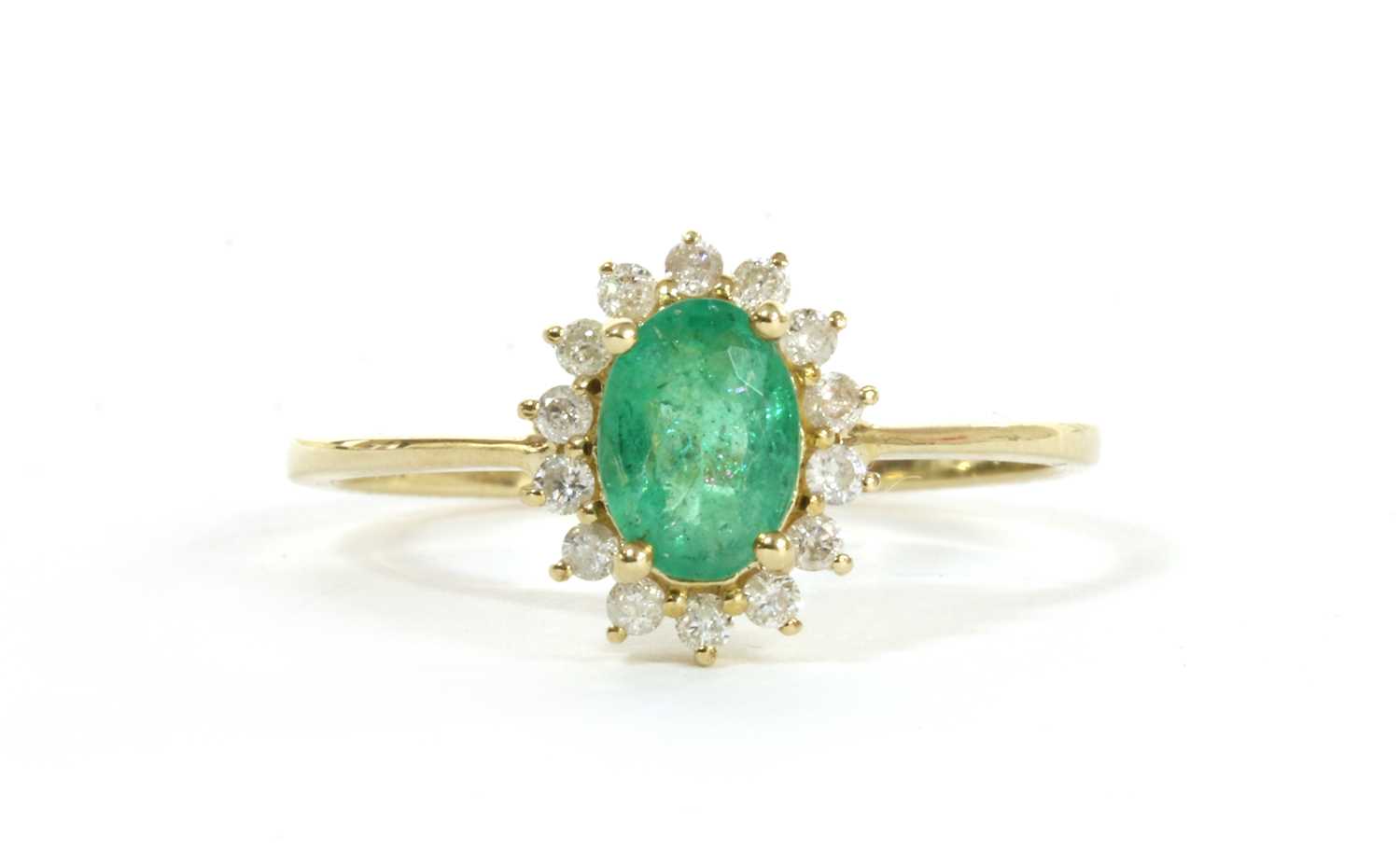 Lot 159 - A gold emerald and diamond cluster ring