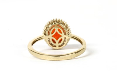 Lot 251 - A gold fire opal and diamond cluster ring