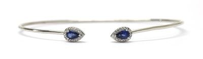 Lot 285 - A silver sapphire and diamond torque bangle
