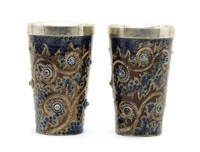 Lot 134 - A pair of Doulton Lambeth stoneware and silver mounted beakers