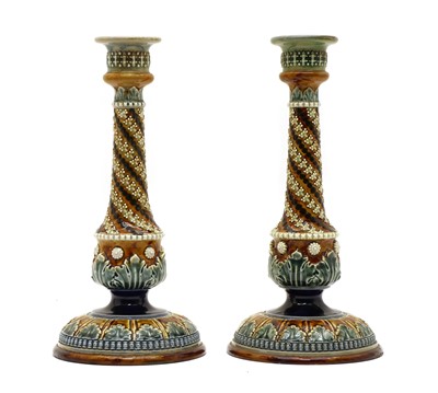 Lot 136 - A pair of Doulton Lambeth stoneware candlesticks