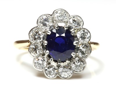 Lot 463 - A sapphire and diamond oval cluster ring