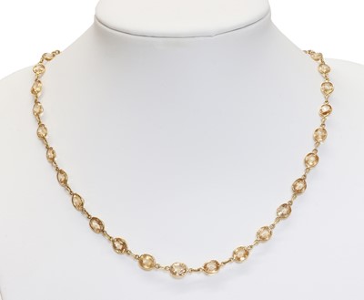 Lot 220 - A gold hessonite garnet rivière necklace