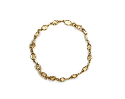 Lot 1181 - A gold hessonite garnet bracelet