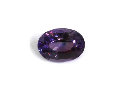 Lot 1404 - An unmounted oval mixed cut purple sapphire