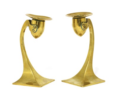 Lot 138 - A pair of Arts and Crafts brass candlesticks