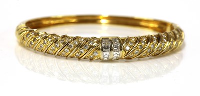 Lot 393 - An 18ct gold diamond set oval hinged bangle