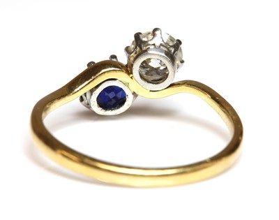 Lot 273 - A sapphire and diamond crossover ring