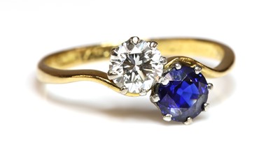 Lot 273 - A sapphire and diamond crossover ring