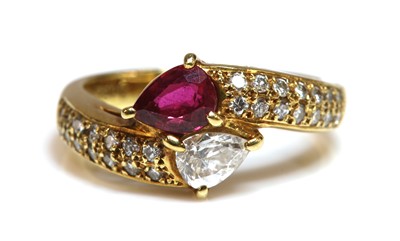 Lot 479 - A gold ruby and diamond crossover ring