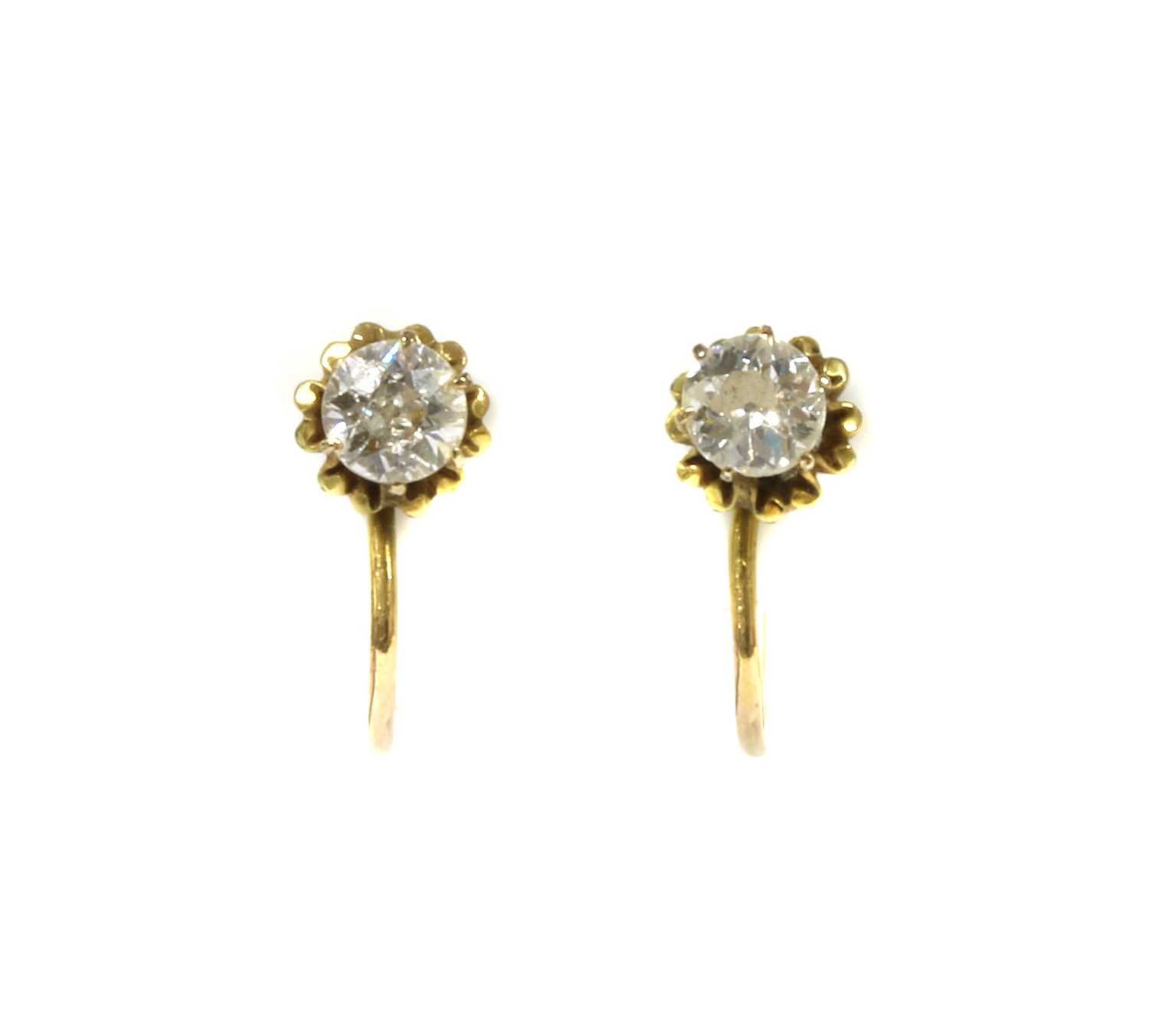 Lot 1036 - A pair of gold single diamond earrings