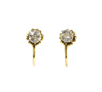 Lot 1036 - A pair of gold single diamond earrings