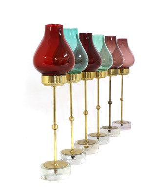 Lot 608 - A set of six brass and glass candlesticks
