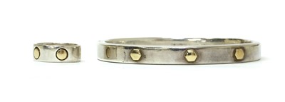 Lot 211 - A sterling silver and gold bangle