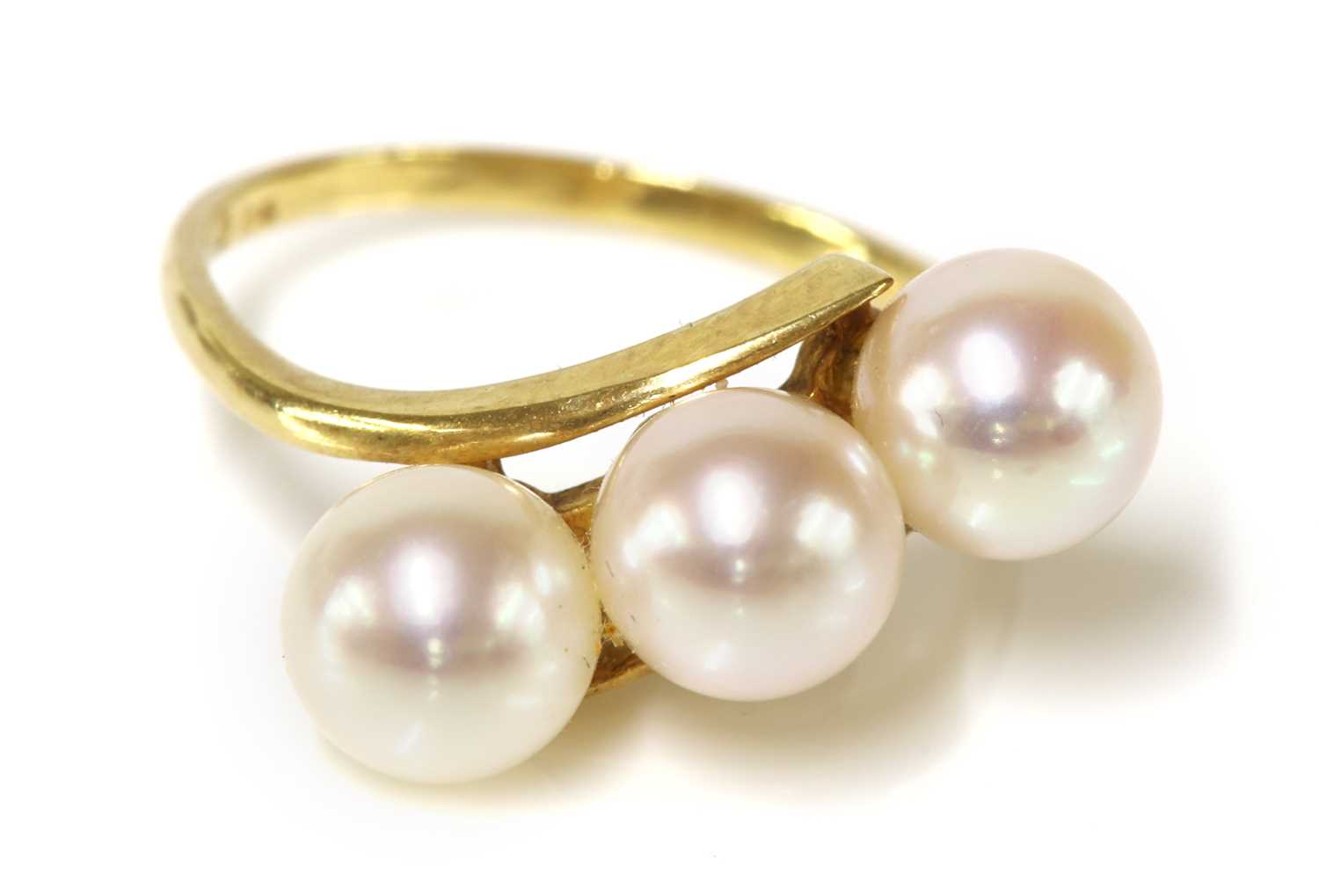 Lot 307 - A three stone cultured pearl crossover ring, by Mikimoto