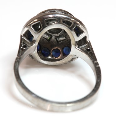 Lot 261 - A white gold diamond and sapphire circular stepped cluster ring