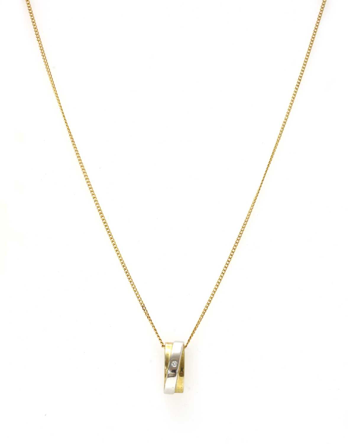 Lot 136 - A two colour gold diamond pendant