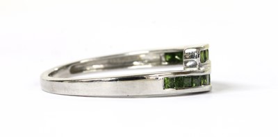 Lot 168 - A 9ct white gold treated green diamond crossover ring