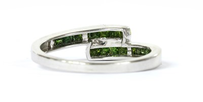 Lot 168 - A 9ct white gold treated green diamond crossover ring