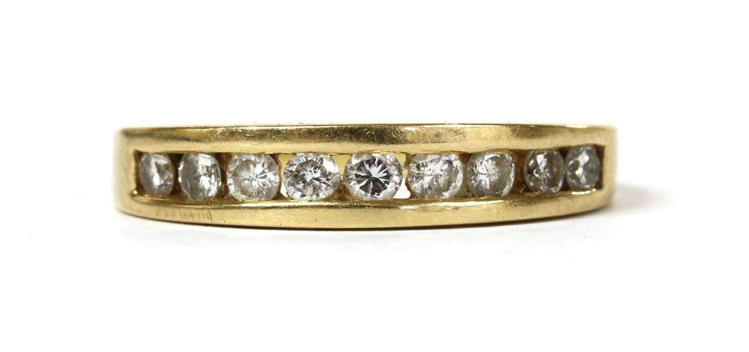 Lot 58 - An 18ct gold diamond half eternity ring