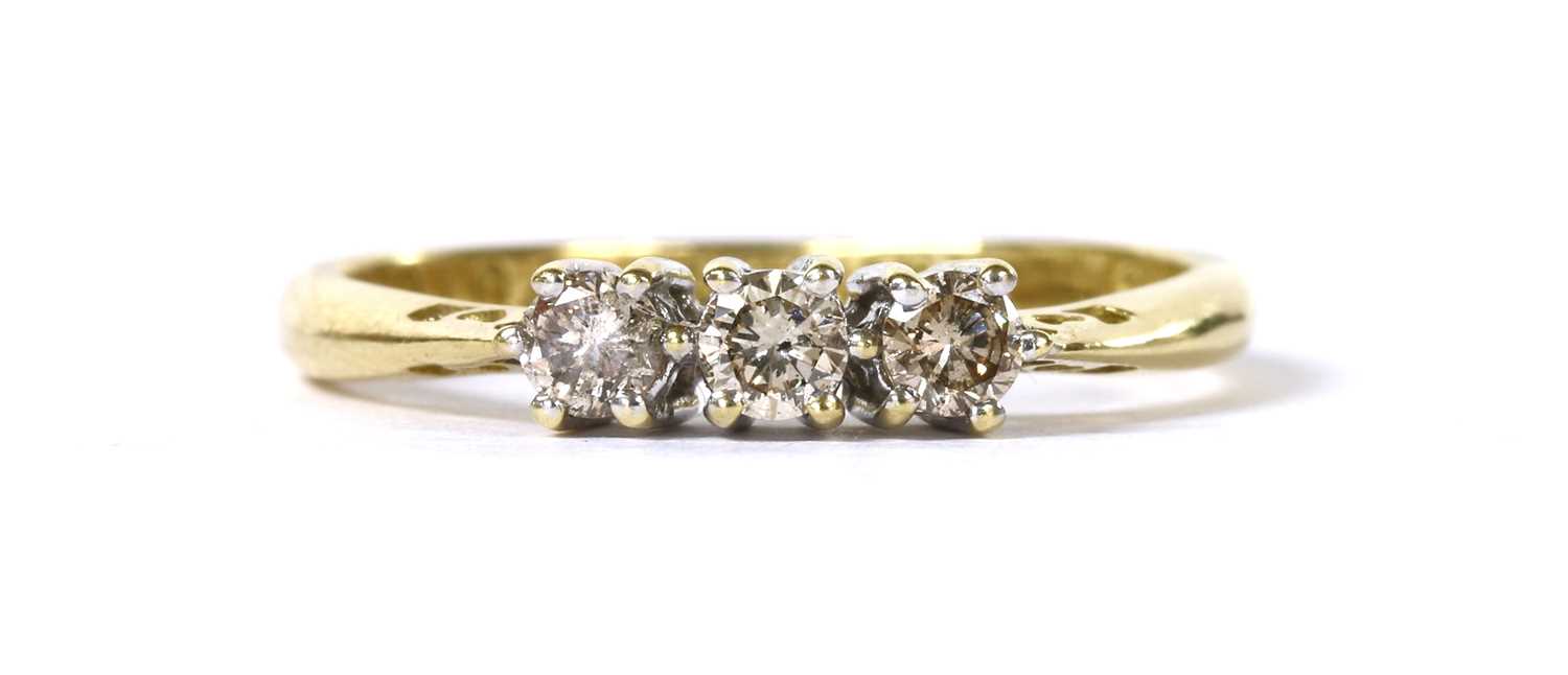 Lot 104 - An 18ct gold three stone diamond ring