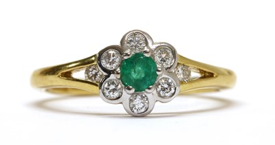 Lot 273 - An 18ct gold emerald and diamond daisy cluster ring