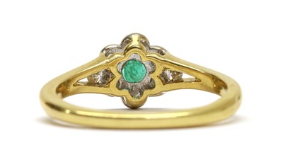 Lot 273 - An 18ct gold emerald and diamond daisy cluster ring