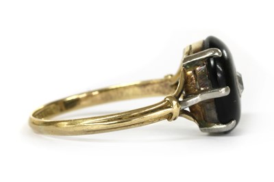 Lot 1066 - A gold diamond and onyx ring