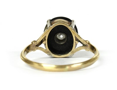 Lot 1066 - A gold diamond and onyx ring