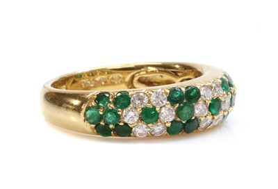 Lot 476 - An 18ct gold emerald and diamond pavé set bombé form half hoop ring