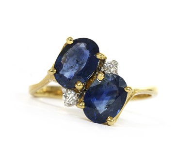 Lot 1221 - An 18ct gold sapphire and diamond crossover ring