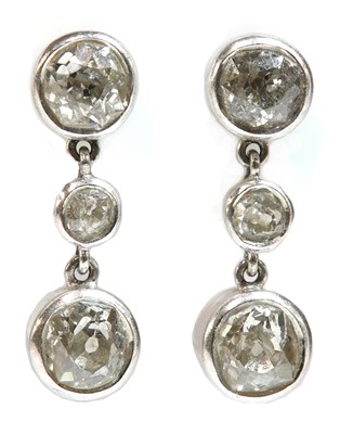 Lot 201 - A pair of three stone diamond drop earrings