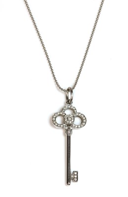 Lot 493 - An 18ct white gold diamond set 'Crown Key' pendant, by Tiffany & Co.