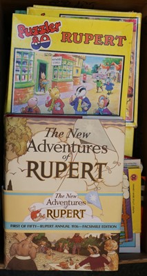 Lot 92 - An assortment of Rupert the bear annuals and jigsaws
