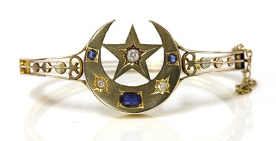 Lot 136 - An Edwardian sapphire and diamond closed crescent and star bangle, c.1905