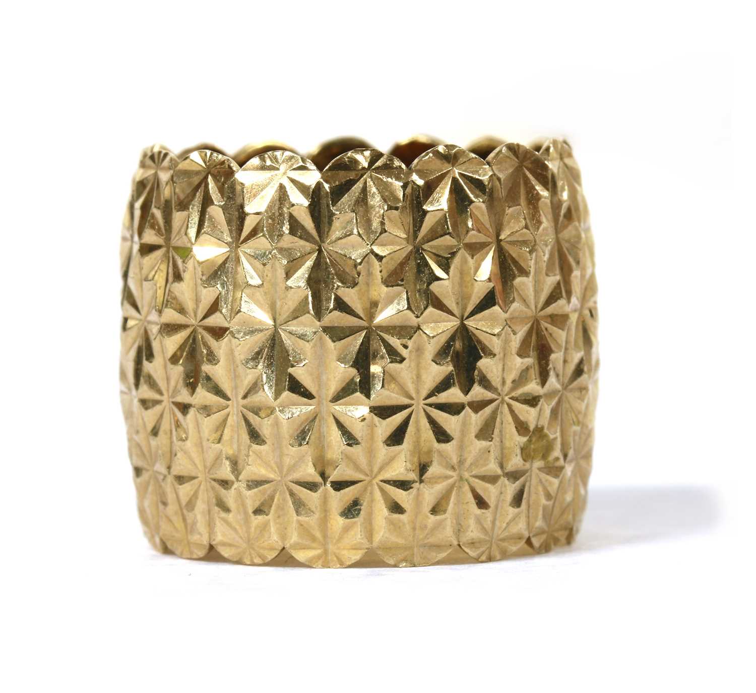 Lot 121 - A 9ct gold wide patterned band ring
