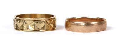 Lot 145 - A 9ct gold patterned flat section wedding ring