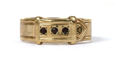Lot 239 - A 9ct gold garnet set buckle ring