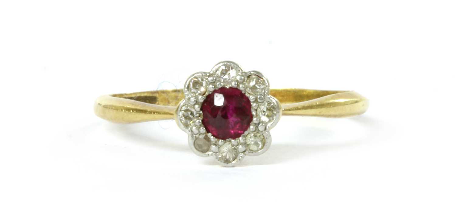 Lot 1035 - A gold ruby and diamond cluster ring