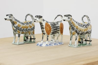 Lot 748 - Three Staffordshire Prattware cow creamers