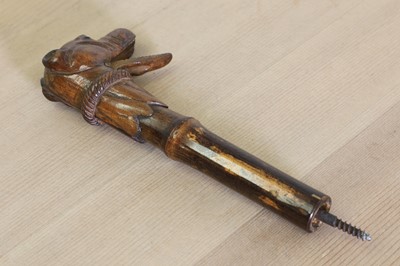 Lot 300 - A carved wooden walking stick or parasol handle