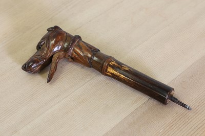 Lot 300 - A carved wooden walking stick or parasol handle